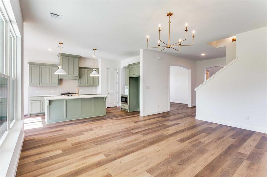 Kitchen featuring plenty of natural light, light wood-type flooring, and green cabinetry