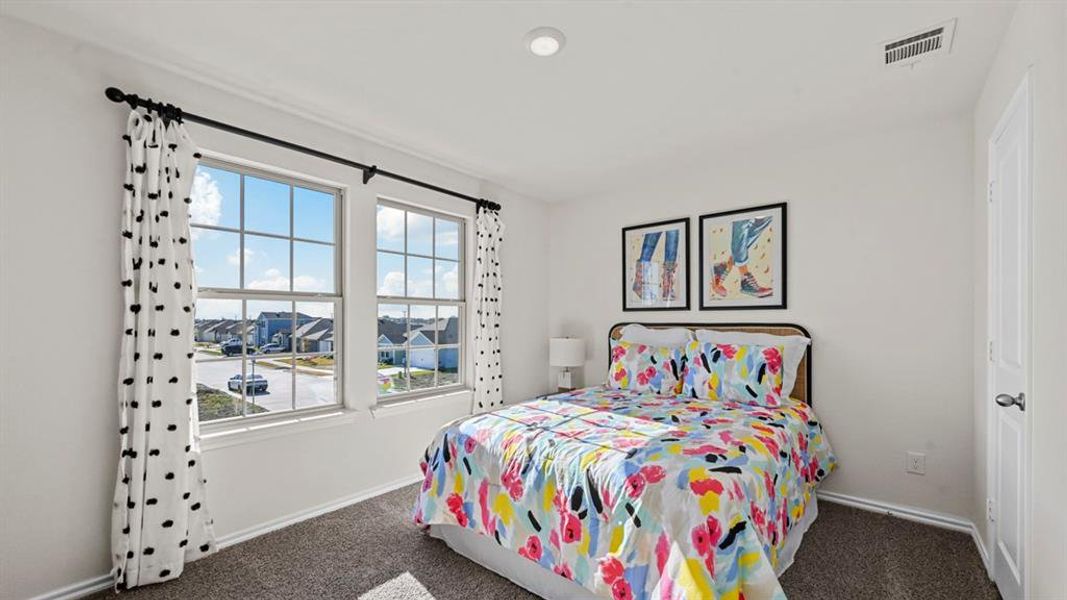 This room features two windows and carpeted floors This room features two windows and carpeted floors
