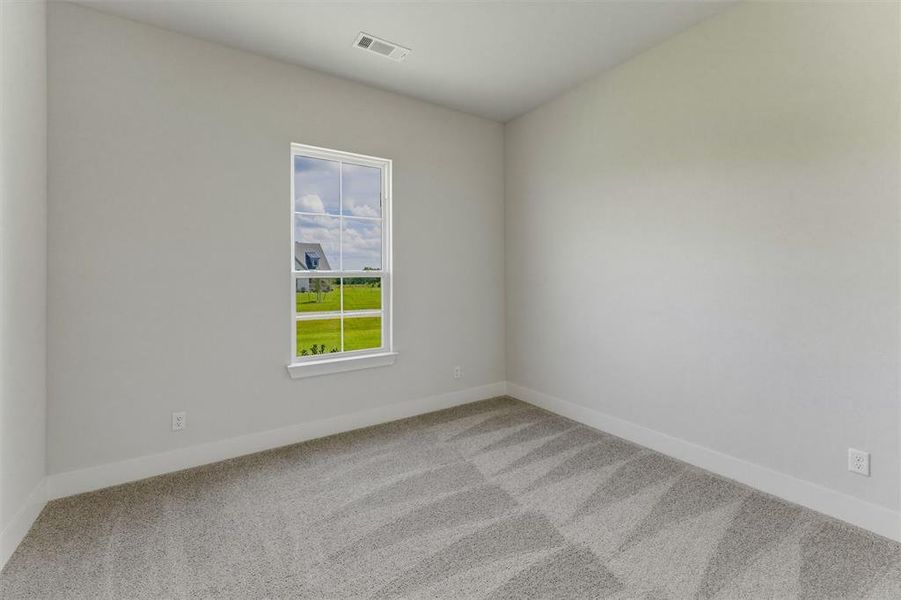 Neutral tone wall finishes, white trim, and patterned carpeting create a versatile interior Neutral tone wall finishes, white trim, and patterned carpeting create a versatile interior