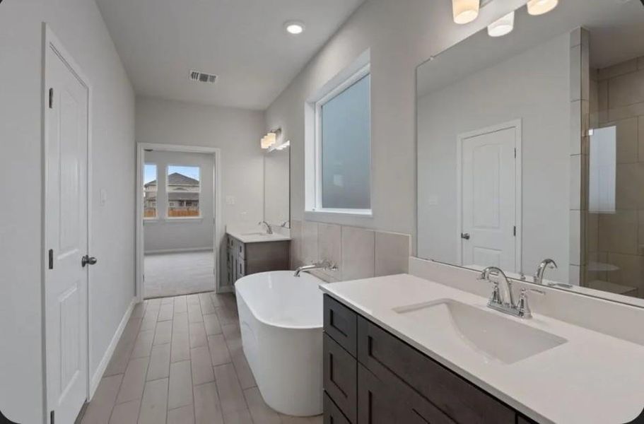 Modern primary bath featuring a separate soaking tub and stand-alone shower—the perfect blend of style and relaxation.