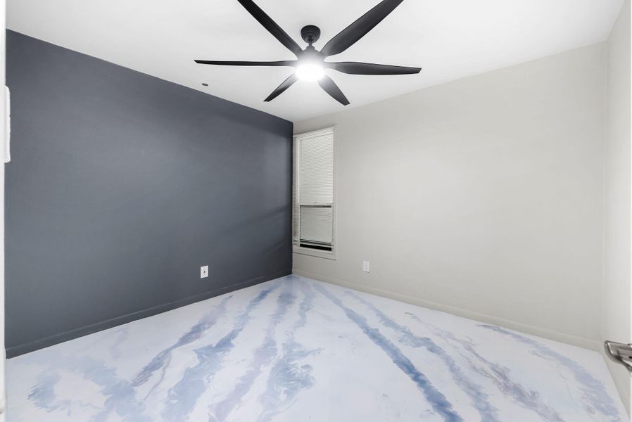 Empty room featuring ceiling fan and baseboards Could be used as office