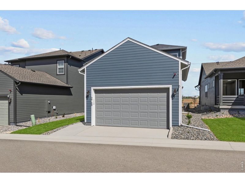 Front exterior of a new home in Kinston Cottage, Loveland, CO, highlighting curb appeal (Image 1). Front exterior of a new home in Kinston Cottage, Loveland, CO, highlighting curb appeal (Image 1).