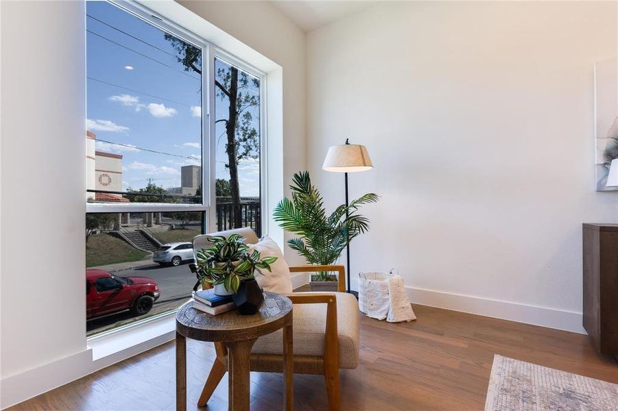 Sitting room with dark wood-type flooring