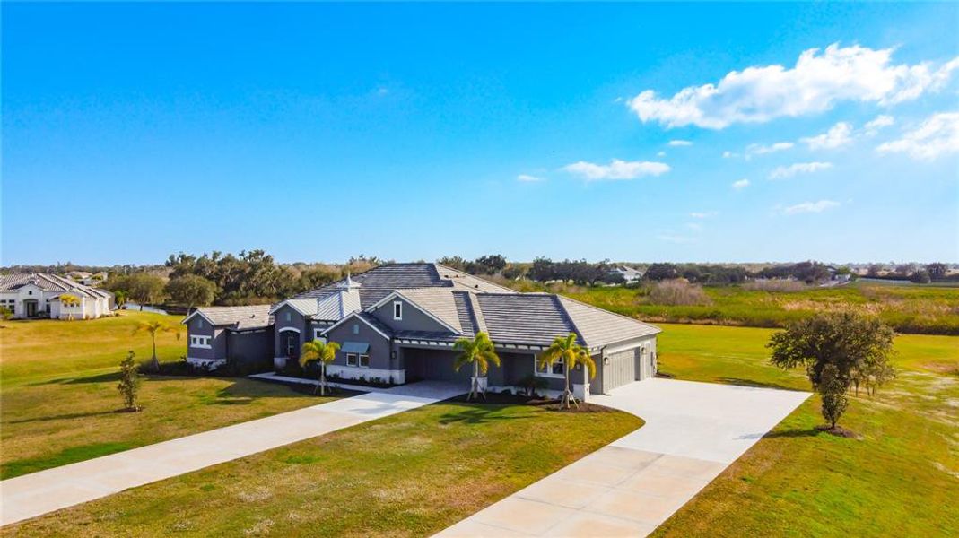 Front exterior of a new home in Hampton Lakes, Sarasota, FL, highlighting curb appeal (Image 2). Front exterior of a new home in Hampton Lakes, Sarasota, FL, highlighting curb appeal (Image 2).