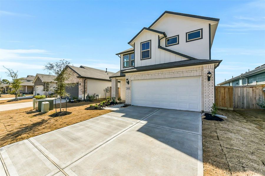 Front exterior of a new home in Colony at Pinehurst, Pinehurst, TX, highlighting curb appeal (Image 1). Front exterior of a new home in Colony at Pinehurst, Pinehurst, TX, highlighting curb appeal (Image 1).
