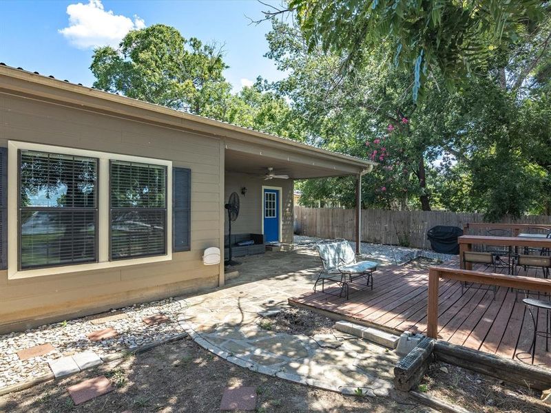 Wooden deck featuring a fenced backyard and outdoor dining space Wooden deck featuring a fenced backyard and outdoor dining space