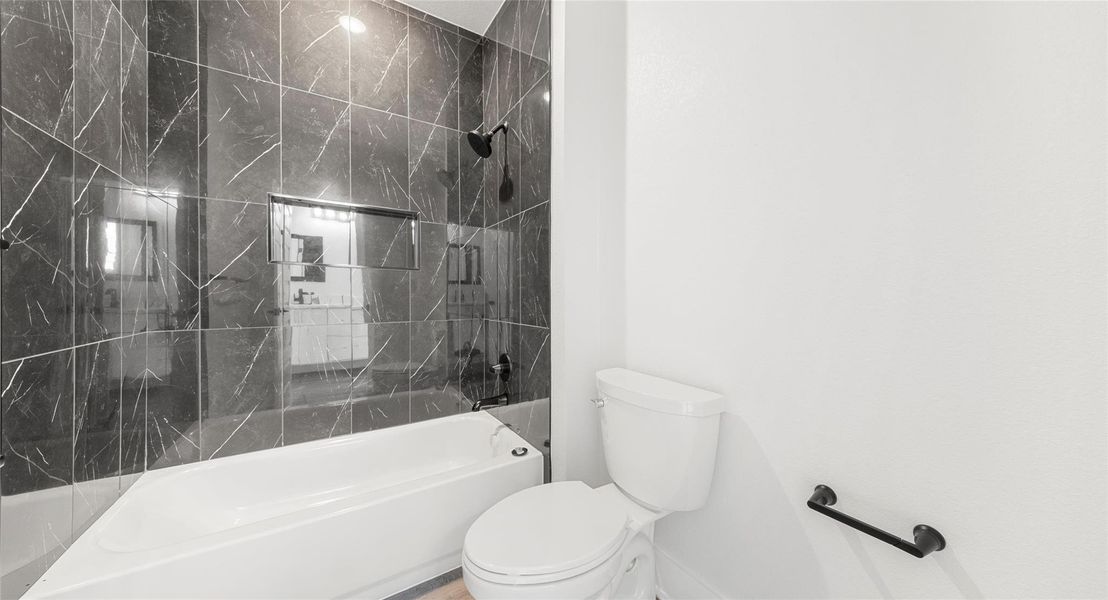 Full bath featuring toilet and shower / bathtub combination