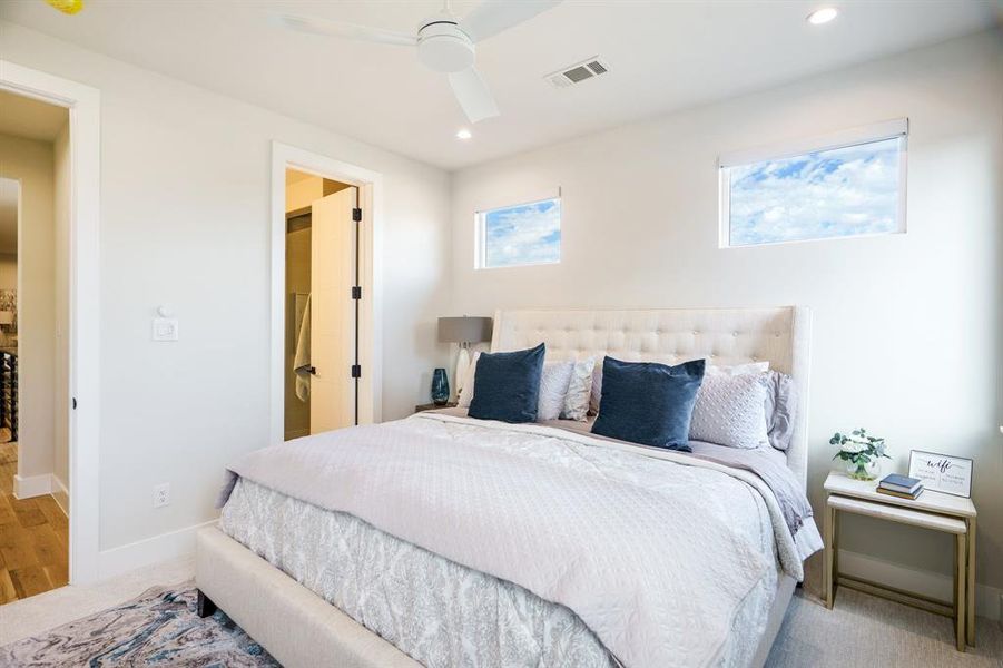 Carpeted bedroom featuring ceiling fan