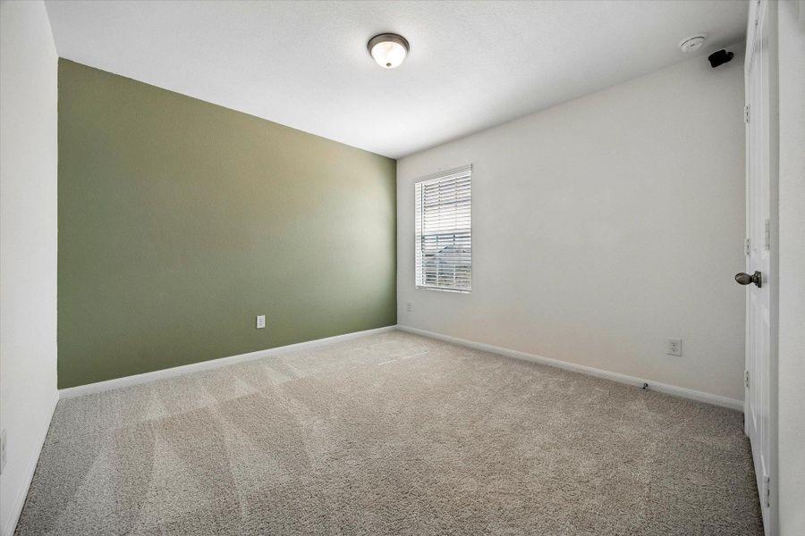 Unfurnished room with light colored carpet and baseboards