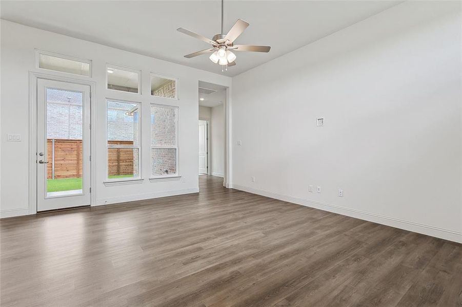 Spare room featuring ceiling fan and dark hardwood / wood-style flooring