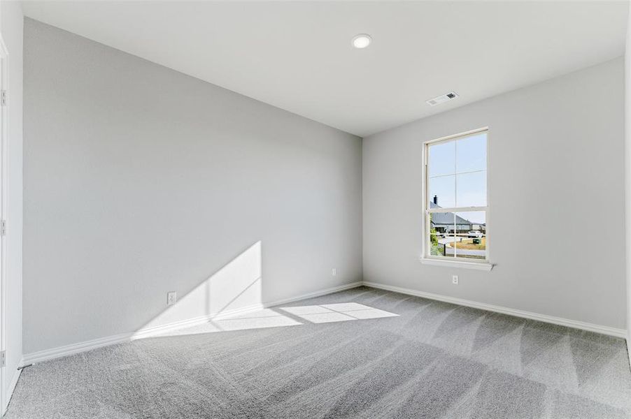 Empty room with light carpet and baseboards