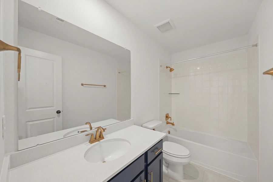 Second bath. "Note: Sample product photo. Actual exterior and interior selections may vary by homesite. Photo may be virtually staged