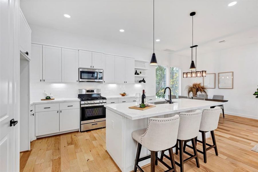 The kitchen provides ample storage space and counter space, with the bar providing a great space for a quick meal! (Model Unit 9424C)