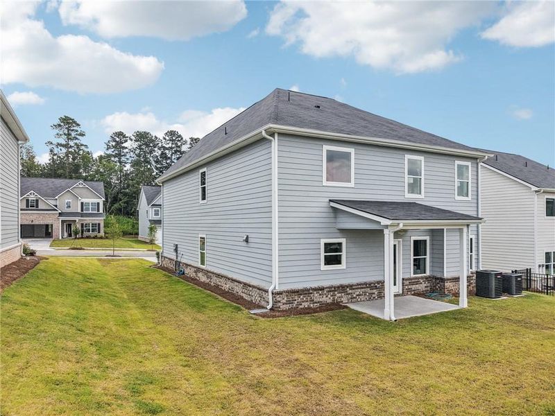 Exterior details and patio area of a home in The Hills at Cedar Creek, Winder (Image 26).