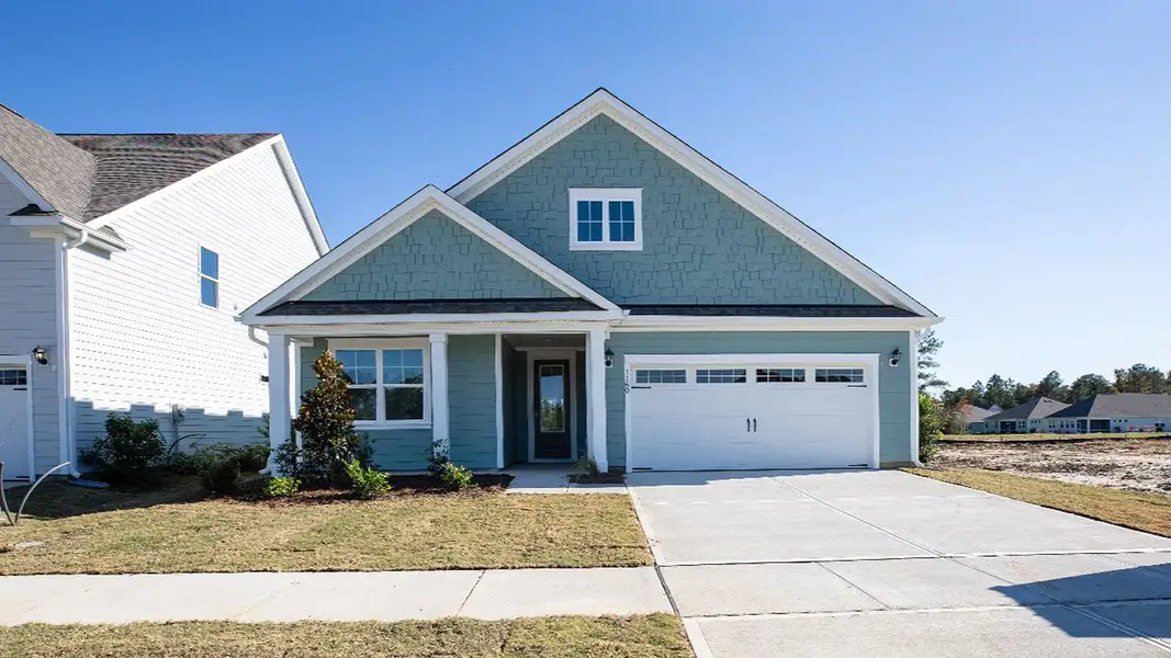 Front exterior of a new home in Indigo Preserve, Leland, NC, highlighting curb appeal (Image 1).