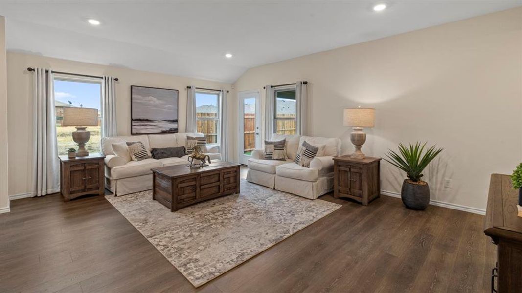 Living room with recessed lighting, dark wood finished floors, and lofted ceiling