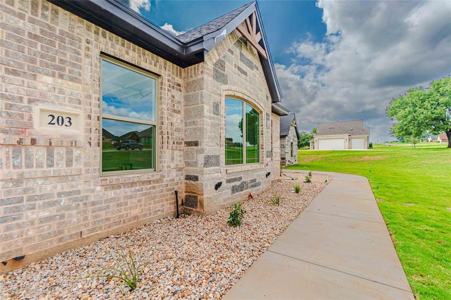 View of side of home featuring a yard