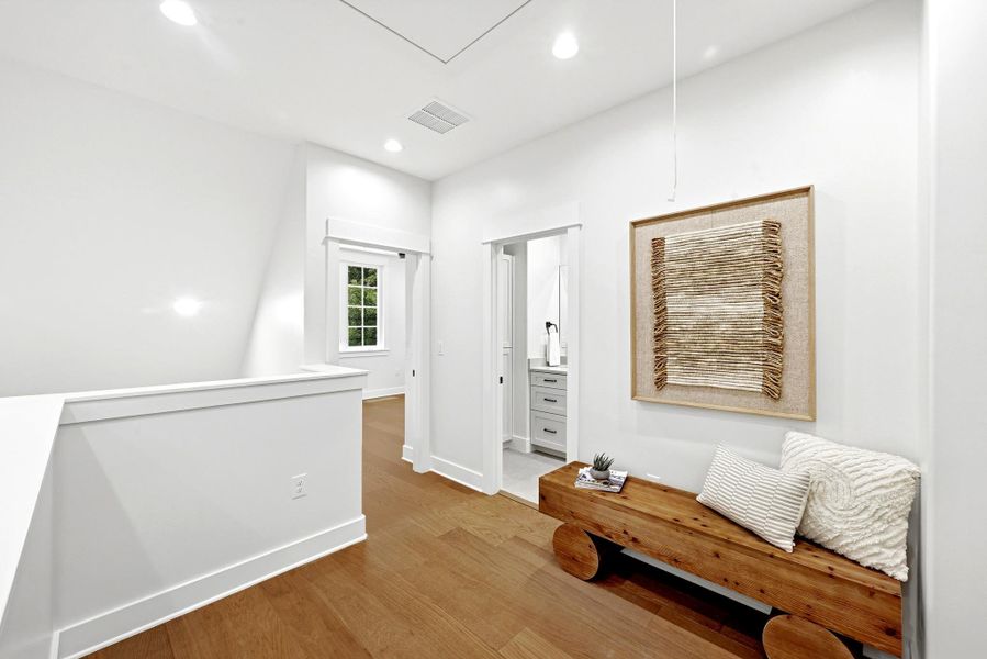 Hardwood floors and crisp white walls create a clean, modern aesthetic in this inviting landing space. Hardwood floors and crisp white walls create a clean, modern aesthetic in this inviting landing space.