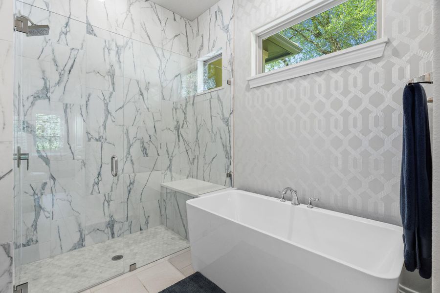 The freestanding soaking tub creates a true spa-like focal point in the primary bathroom. The freestanding soaking tub creates a true spa-like focal point in the primary bathroom.