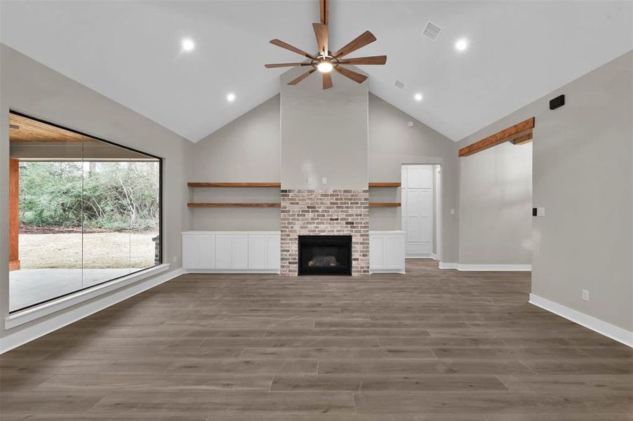 Another view of your living area and gas fireplace from the kitchen.  Large open window to bring in the peaceful, wooded backyard!