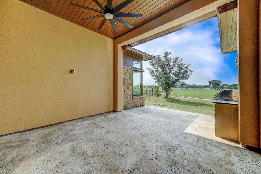 Covered back patio with built in gas grill and oversized fan, and golf course views!