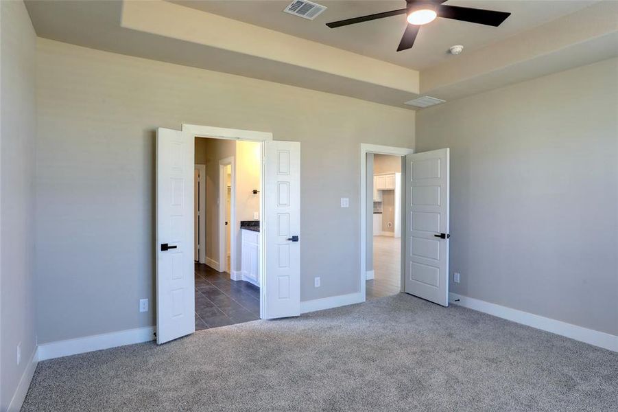 Unfurnished bedroom with carpet and ceiling fan Unfurnished bedroom with carpet and ceiling fan