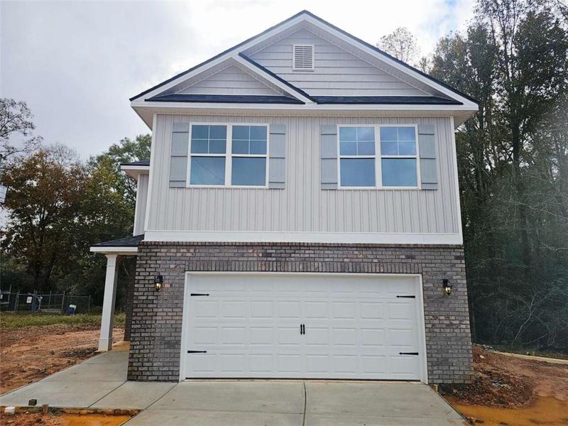 Front exterior of a new home in Scarlett Place, Bowdon, GA, highlighting curb appeal (Image 2). Front exterior of a new home in Scarlett Place, Bowdon, GA, highlighting curb appeal (Image 2).
