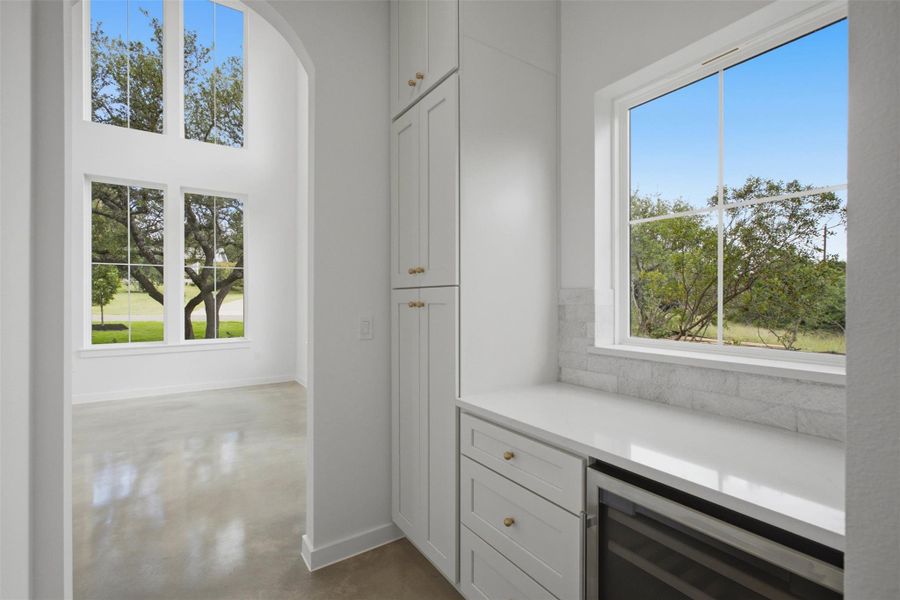 open pantry two sided to include Wine fridge quartz counter and Pantry cabinets as well as a walk in open pantry two sided to include Wine fridge quartz counter and Pantry cabinets as well as a walk in