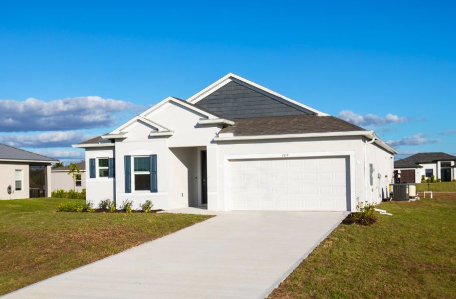 Front exterior of a new home in Burnt Store, Cape Coral, FL, highlighting curb appeal (Image 2). Front exterior of a new home in Burnt Store, Cape Coral, FL, highlighting curb appeal (Image 2).
