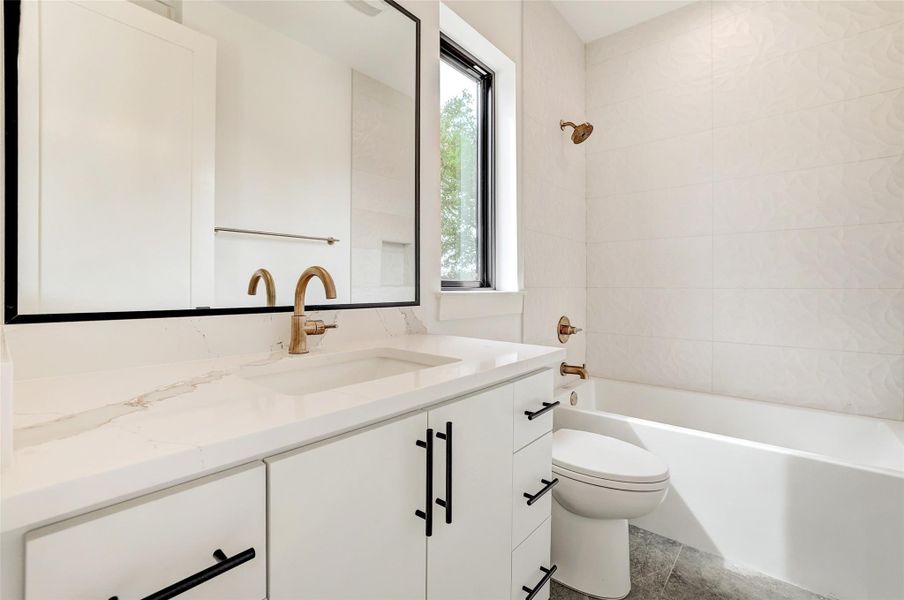 Full bathroom featuring vanity and tub / shower combination Full bathroom featuring vanity and tub / shower combination