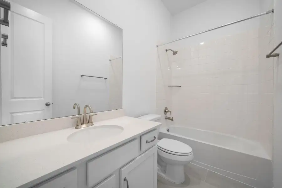 The secondary bath features tile flooring, white cabinetry and light countertops and a shower/tub combo. Perfect for accommodating any visiting family and friends. The secondary bath features tile flooring, white cabinetry and light countertops and a shower/tub combo. Perfect for accommodating any visiting family and friends.