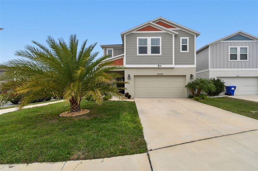 Front exterior of a new home in Pasadena Point, Wesley Chapel, FL, highlighting curb appeal (Image 2).