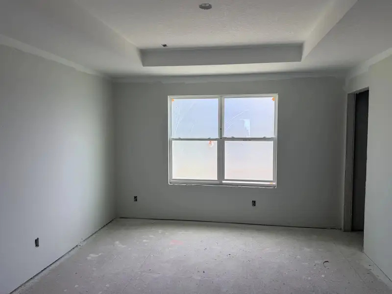 Primary bedroom with a tray ceiling - under construction Primary bedroom with a tray ceiling - under construction