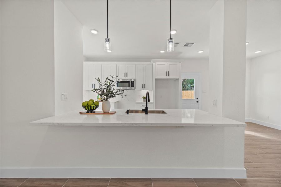 The kitchen features a large breakfast bar that offers plenty of seating for casual dining or entertaining guests. The kitchen features a large breakfast bar that offers plenty of seating for casual dining or entertaining guests.