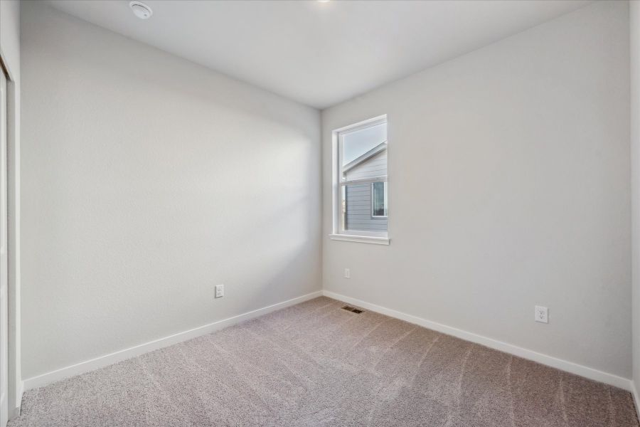 A room with a carpet and a window. A room with a carpet and a window.