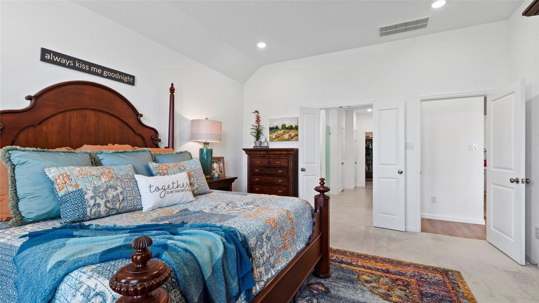 A second view of the spacious primary suite highlights the soaring ceilings, generous space for your furnishings, and convenient access to the private bathroom. A second view of the spacious primary suite highlights the soaring ceilings, generous space for your furnishings, and convenient access to the private bathroom.