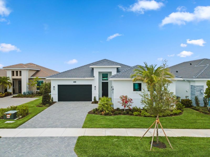 Front exterior of a new home in Cresswind Palm Beach at Westlake, Westlake, FL, highlighting curb appeal (Image 32). Front exterior of a new home in Cresswind Palm Beach at Westlake, Westlake, FL, highlighting curb appeal (Image 32).