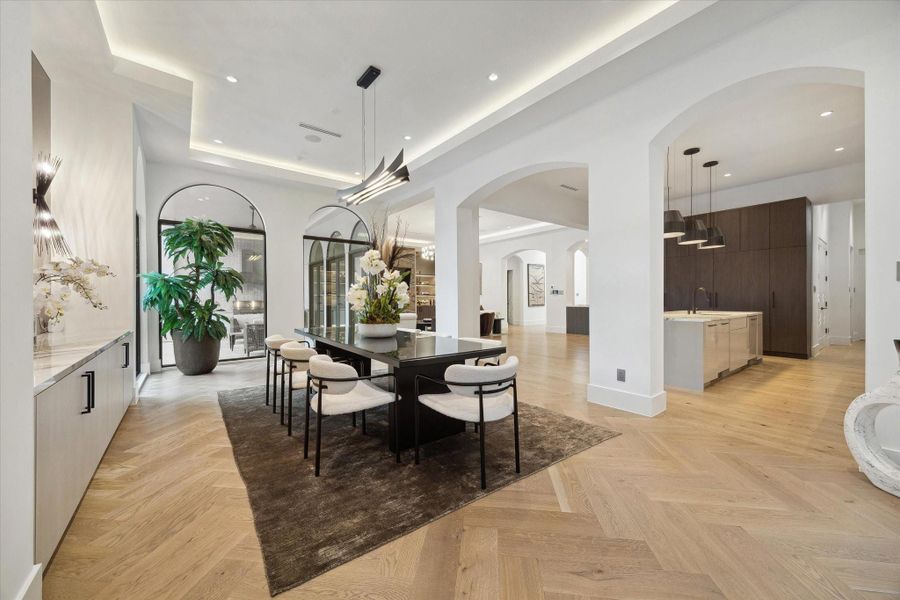 A sophisticated dining room complete with elegant chandelier and pool view