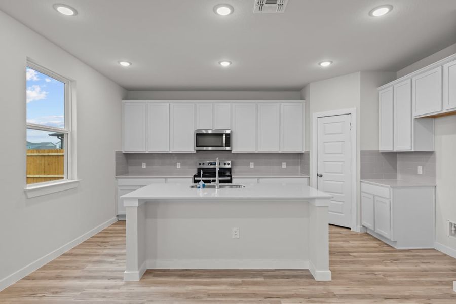 A kitchen with white cabinets. A kitchen with white cabinets.