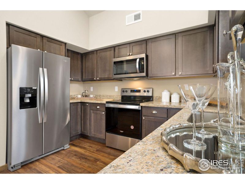 Spacious kitchen with granite and soft close cabinetry