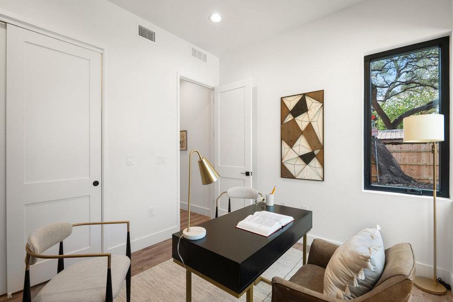 Office space featuring wood finished floors and recessed lighting