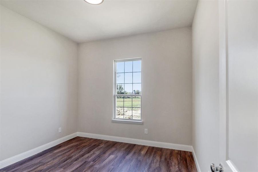 Empty room featuring dark wood-type flooring