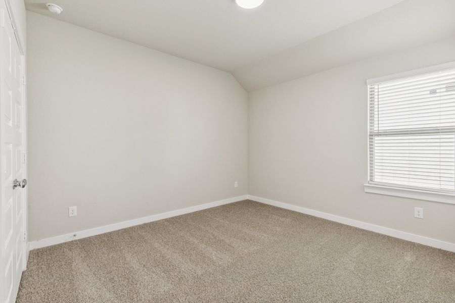 Bedroom in the Heisman home plan by Trophy Signature Homes – REPRESENTATIVE PHOTO