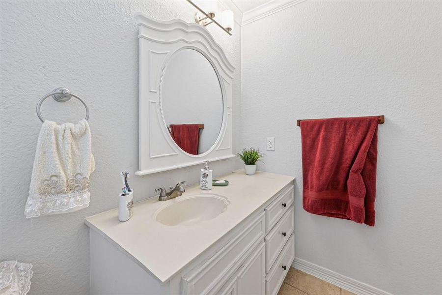 Alternate view of second-level bath featuring vanity, framed mirror, and neutral finishes.