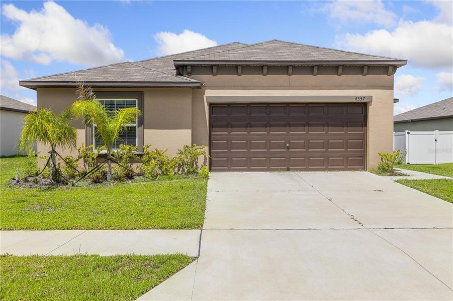 Front exterior of a new home in Wind Meadows South, Bartow, FL, highlighting curb appeal (Image 29).