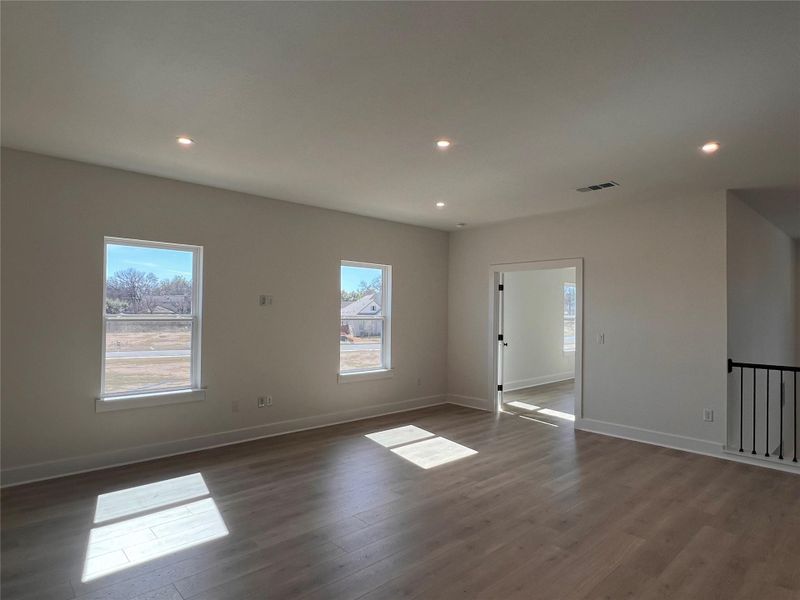 Empty room with recessed lighting, healthy amount of natural light, and wood finished floors