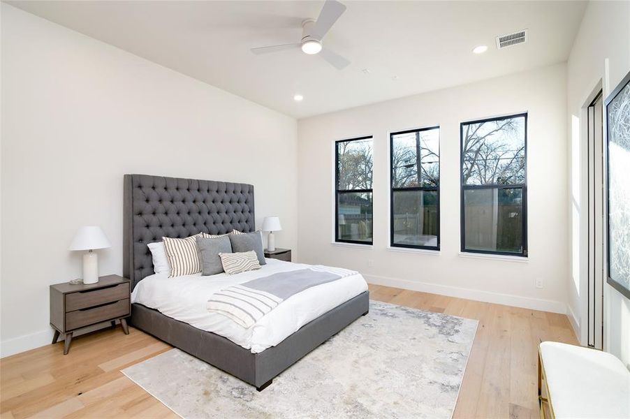 Bedroom featuring wood-type flooring and ceiling fan