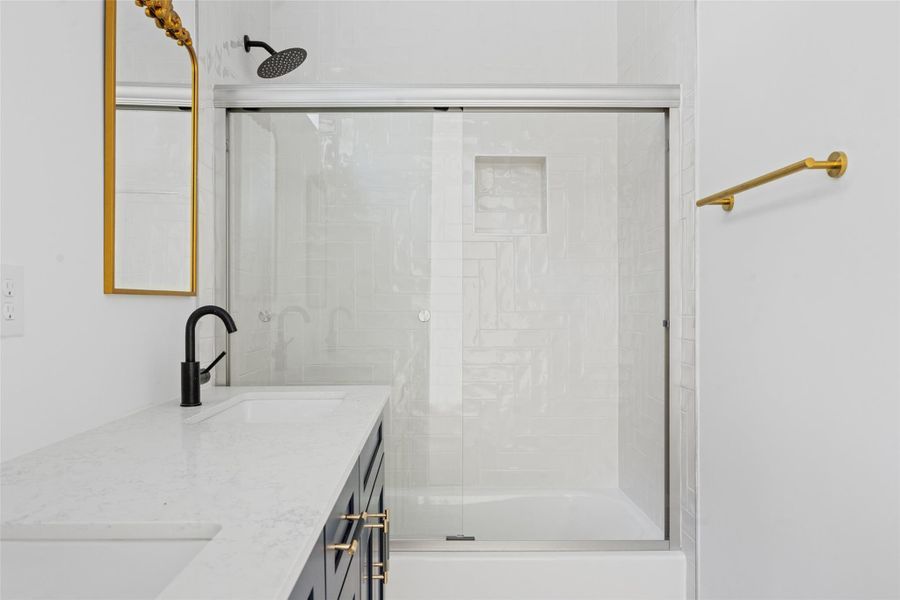 Bathroom with bath / shower combo with glass door and double vanity Bathroom with bath / shower combo with glass door and double vanity