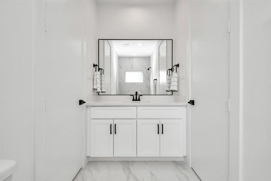 Picturesque large vanity and ample cabinet space complete the luxurious aesthetics of this gorgeous Jack and Jill