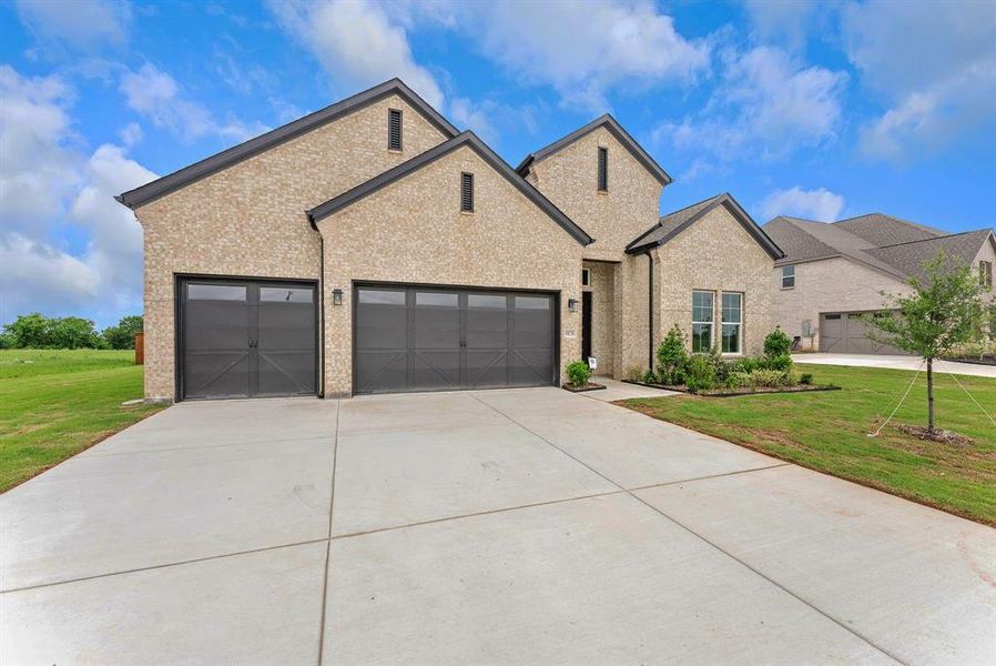 Front exterior of a new home in Polo Ridge, Mesquite, TX, highlighting curb appeal (Image 1). Front exterior of a new home in Polo Ridge, Mesquite, TX, highlighting curb appeal (Image 1).